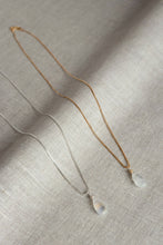 Load image into Gallery viewer, Two necklaces with teardrop moonstone pendants on a textured beige surface
