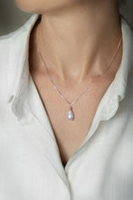 Load image into Gallery viewer, Necklace with a moonstone pendant worn by a person in a white shirt
